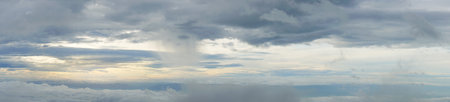 Panorama of the sky. The thick morning clouds below were covered with a thick fog of clouds. And the yellow light of the sun was seen. for background and textured.の写真素材