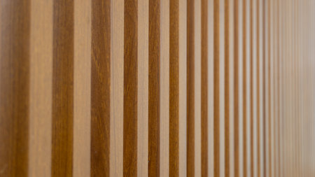 A clear to blurred view of a light brown wooden wall panel. Minimalistic wood tones. for Used for...