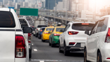 Rear side of pickup car white color traffic jam on the asphalt road. Many cars are parked in a row on the road due to heavy traffic. Blurry of many cars on the expressway.の写真素材