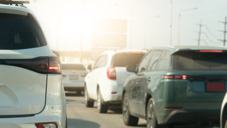 Rear side view of car with turn on brake light. Traffic jam with many car on the road with blurred...