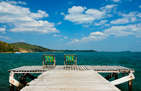 wooden chair on the jetty at koh samet, rayong,thailandの写真素材