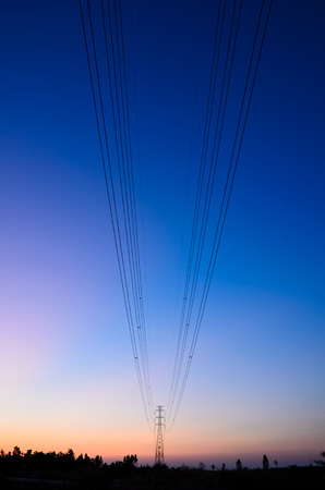 high voltage transmission towers with blue sky during a beautiful sunset の写真素材