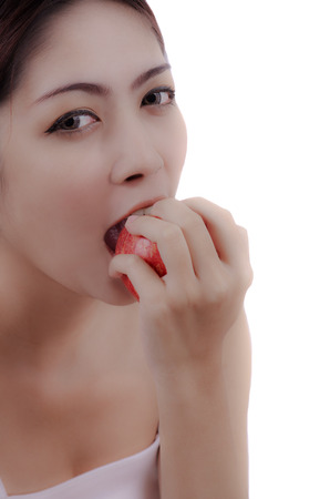  beautiful woman eating an apple on white backgroundの写真素材