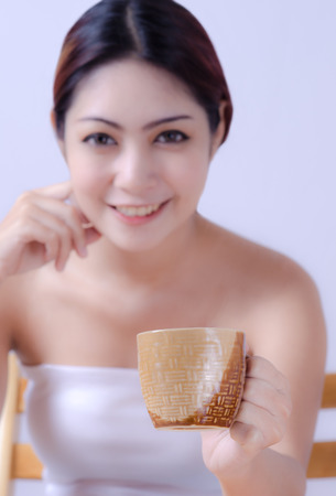 close up a coffee cup  in hand  beautiful young womanの写真素材