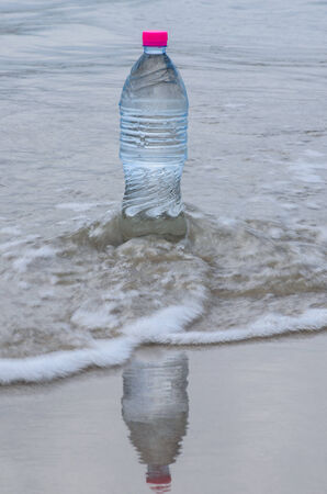 drinking water in bottle on the beachの写真素材