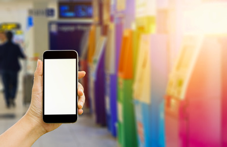 Image of hand woman holding mobile phone with blank white screen for your text message,Use smartphone to transact , Money Transactions through Smartphones instead of ATMs.の写真素材