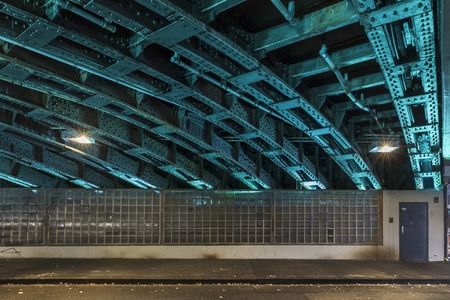 Underpass steel truss lit up at nightの写真素材