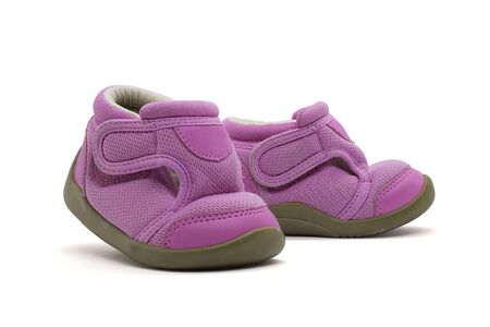 Cute pink baby girl sneakers close up on white background with clipping pathの写真素材