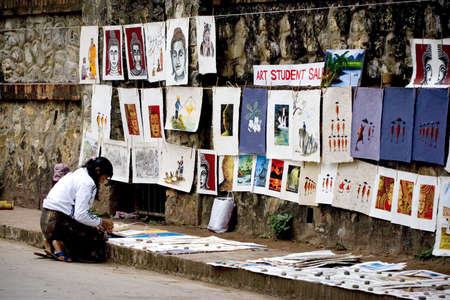 The Student Learn Art  in Lao Sell Painting on Footpath, Hang Photo and Painting on The wall and Lay it on Footpath.のeditorial素材
