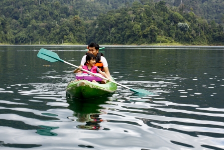 Family , Dad , Mum Daugther, son are Enjoy with Swimming  in Lake at Holidayの写真素材