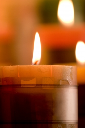 Set Fire with Orange Candle,One Candle in front in focus, Two Candles in background are out of focus の写真素材