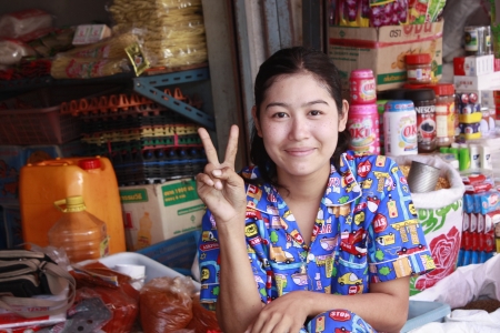 Lifestyle of Myanmar People. Old style Market or Grocery sell food, meat, fish, vegetable,canned food,tobacco leaf, garment, gold, gem, electronic, computer, mobile and etc. People still wear sarong. woman make up with Tanaka or Thanaka Powder.のeditorial素材