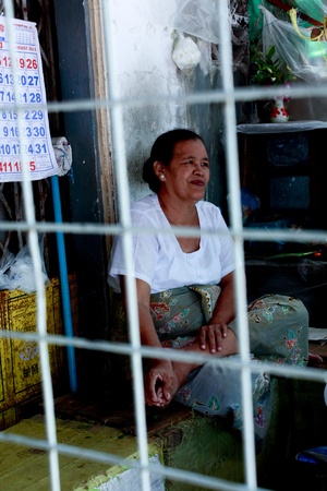 Lifestyle of Myanmar People. Old style Market or Grocery sell food, meat, fish, vegetable,canned food,tobacco leaf, garment, gold, gem, electronic, computer, mobile and etc. People still wear sarong. woman make up with Tanaka or Thanaka Powder.のeditorial素材
