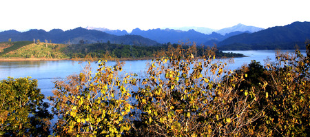  Blue lake and  white Sky in Wide Frame.Tree in warm color by sunset at foreground.Blue Mountain at faraway.の写真素材