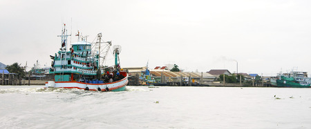 SAMUT SONGKHRAM, THAILAND-AUGUST 2014: Fisherman ship sail back to jetty at morning after fishing at all night.のeditorial素材