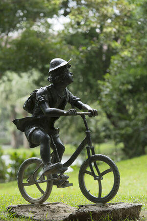 BANGKOK,THAILAND-8 SEPTEMBER 2014: Boy drive bicycle statue in Jatujak Train Public Park,famous and celebrated public park in Bangkok.のeditorial素材