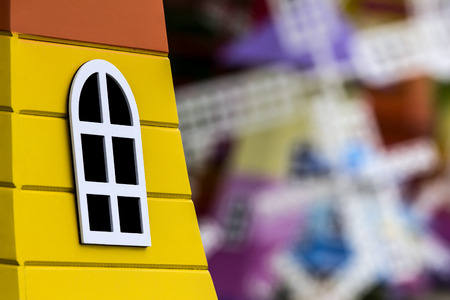 Yellow windmill model and white window.background is out of focus.