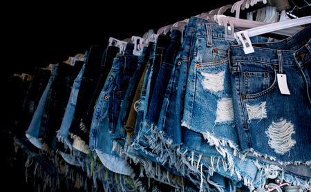 Short knee breeches indigo jeans hang on for display in jeans shop.の写真素材