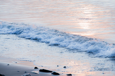 Sea and wave, twist  on the seashore, Reflection in the sea with sunlight at early sunshine.