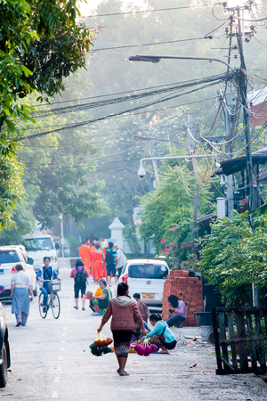 LUANG PRABANG,LAOS - 12 APRIL 2015 :  Laos women back home after offer food to monk.Every day laos people plentifully offer food to monk that is charm and attract for tourist.のeditorial素材