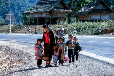 LUANG PRABANG, LAOS - June 15, 2013 : The laos hill tribe teacher and her student back home from school.のeditorial素材