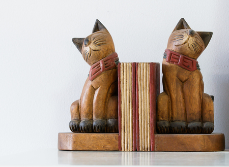 : Two cat wooden dolls for decoration interior on white wall.の写真素材