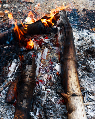 Close up bonfire from wood,black charcoal,ashes and flame by top view shot.の写真素材