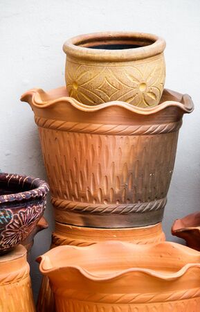 Close up the row of glazed flowerpots and clay flowerpots.の写真素材
