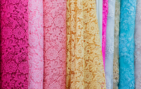 Many color lacework Cloth roll in fabric store closeup shot.の写真素材