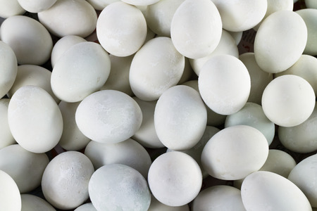 The many salted duck egg lay on basket at local food market, close up shot.