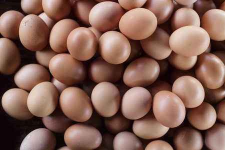 The many hen egg lay on basket at food market, close up shot.の写真素材