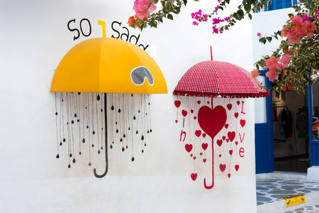 Petchaburi, Thailand - January 10, 2013 : The yellow and red umbrella with heart, Decoration on the wall at playland.のeditorial素材
