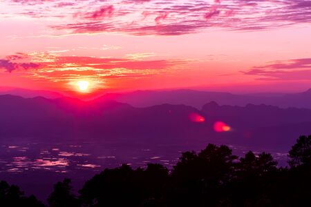 The sunrise scene with mountain and sky in the colorful and vivid.の写真素材
