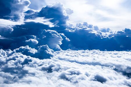 The bright blue sky with the excited white cloud shape.The photo shot with bird eye view from the aeroplane.の写真素材