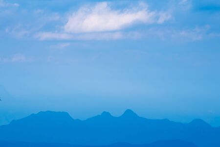 The nearly sunset scene in the winter season with blue mountain and blue sky.の写真素材