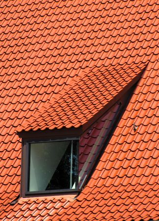 Window in the red tiled roofの写真素材