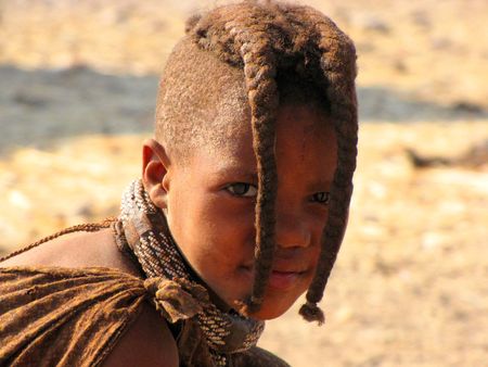 NAMIBIA, KAOKOVELD, AUGUST 29: Himba girl looking to the camera in the village of Himba people near Opuwo in northern Namibia, August 29, 2009, Namibiaのeditorial素材