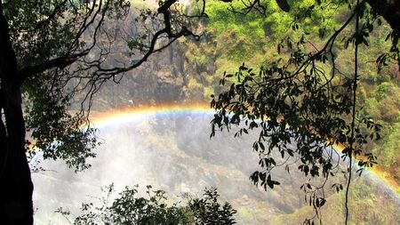Colorful rainbow seen at the Victoria Fallsの写真素材