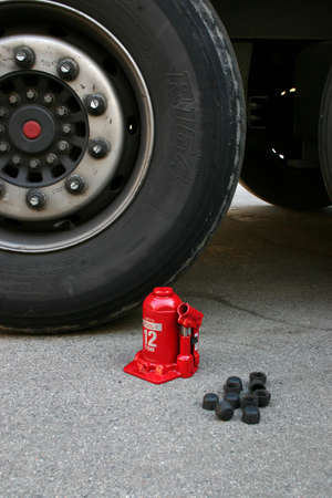 Truck tire with red lifting jackの写真素材
