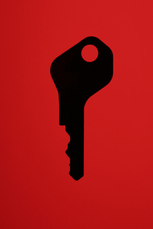 Silhouette Of A Key On A Red Background