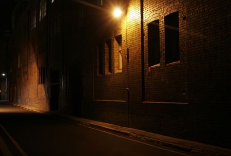 Mysterious Alley - Dark Abandoned Street With Lights Shining On A Brick Wallの写真素材