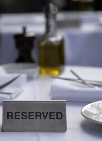 Metallic Silver Reserved Sign On A Restaurant Table