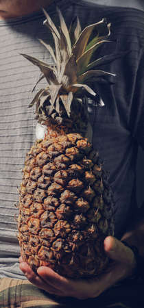 Man holding pineapple in the handの写真素材