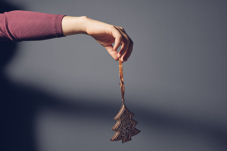 Child hand holding christmas tree decorationの写真素材