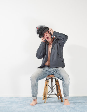 Man waiting for motorcycle season at homeの写真素材