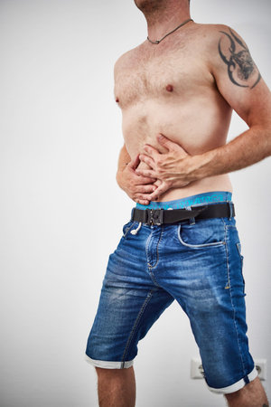 Male holding belly in painの写真素材