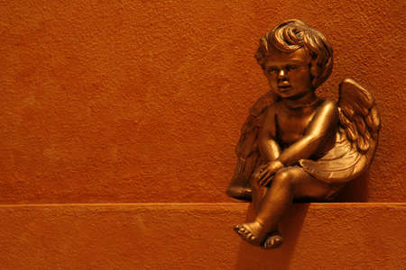 Gold angel on faux painted shelfの写真素材