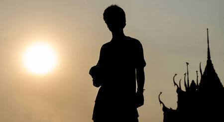 The man in front of the sun and the temple の写真素材