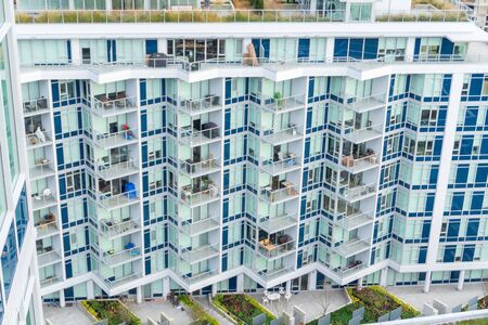 River District condos in a low rise with roof-top garden, side view, with new building construction in background. Vancouver, B.C. Dec 2 2018.のeditorial素材
