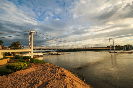The old wooden bridge Bridge (Rattanakosin suspension bridge) across the Ping river (hanging bridge) at Tak Province, thailandのeditorial素材